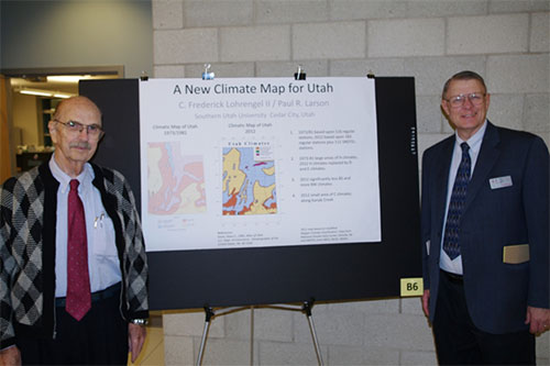 Frederick Lohrengel and Paul Larson standing with their research poster.