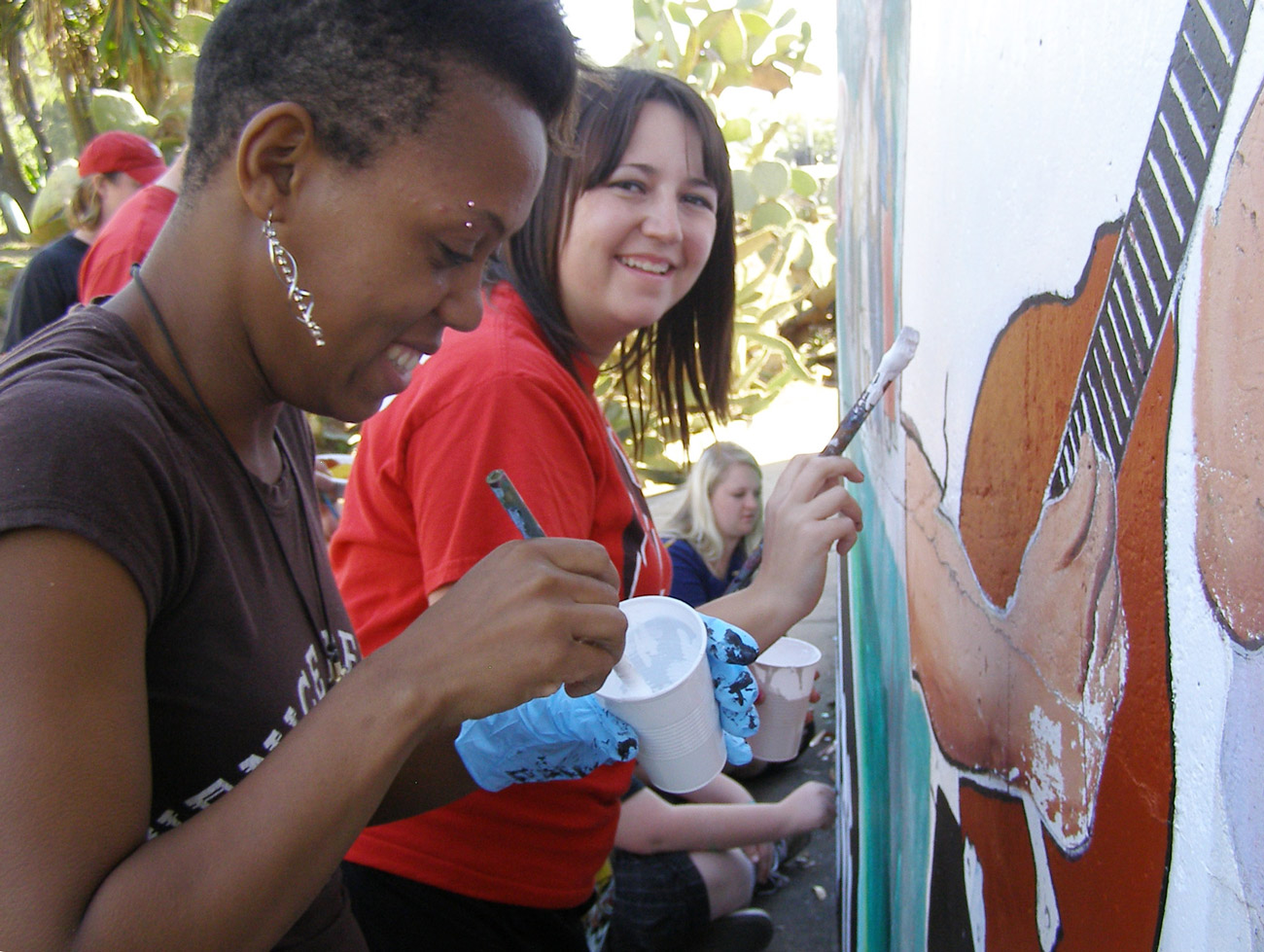 Two SUU students clean a mural in southern California. 