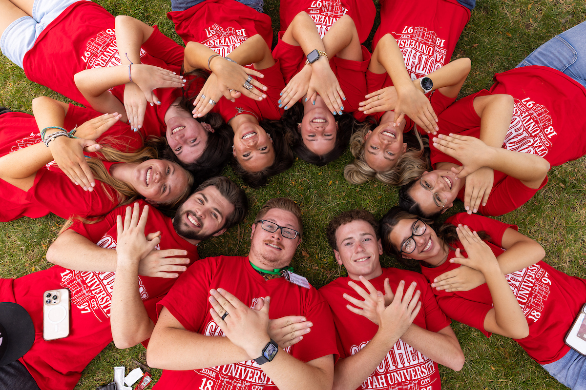 suu students laying in circle showing tbird hand sign for campus connections