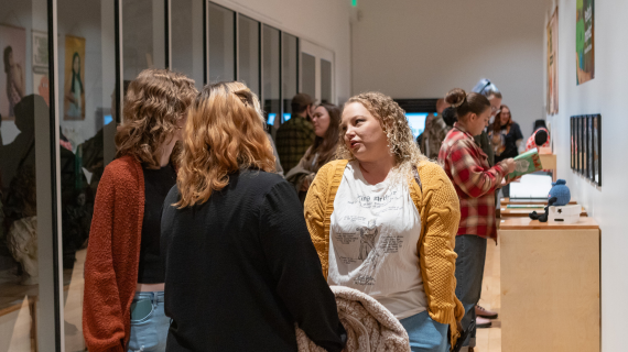 Photo of students attending a BFA Fall Exhibition.