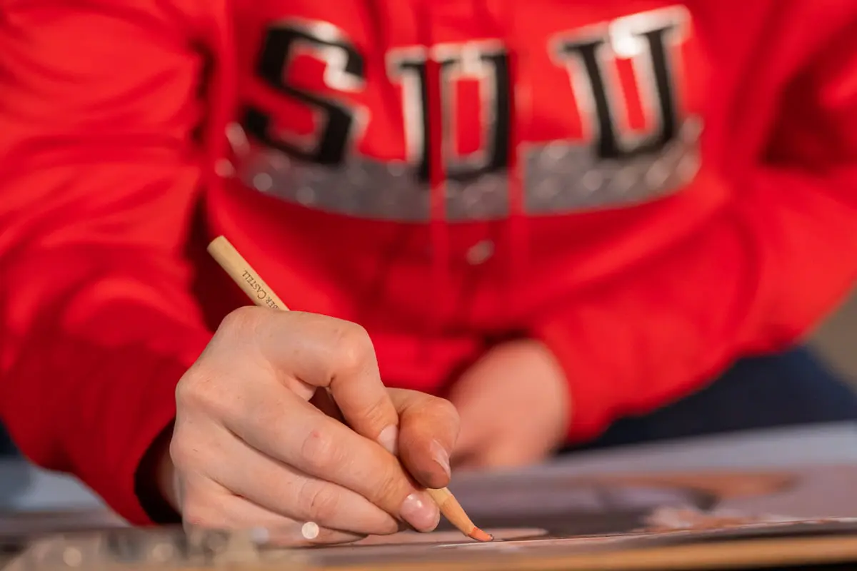 Southern Utah University student drawing in an Art bachelor degree program.