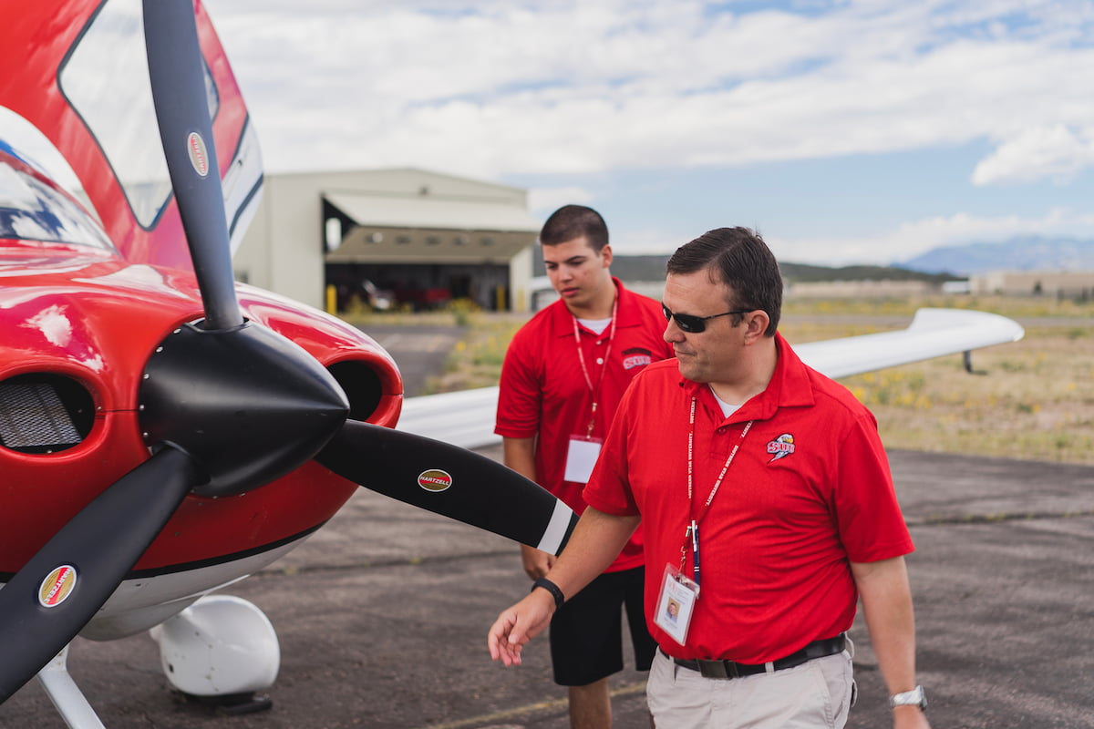 Southern Utah University aviation bachelor degree student and instructor looking at an airplane.