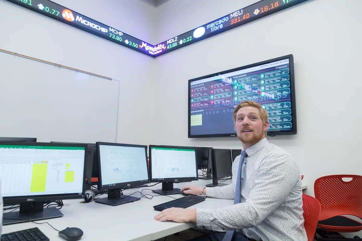 Southern Utah University Economics student in Stock Market Data room.