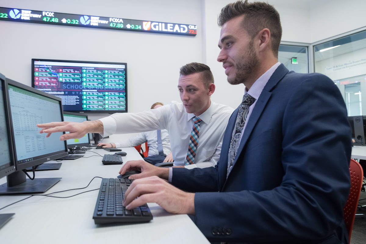 Southern Utah University Finance Students looking at stocks on a computer.