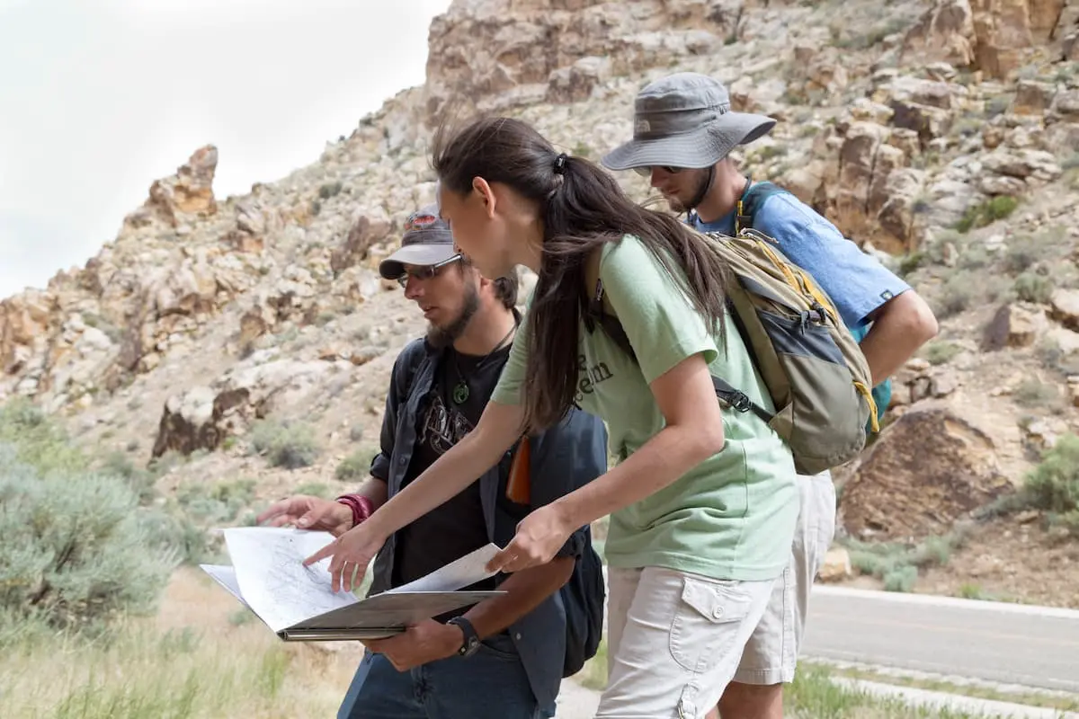 Southern Utah University students look at a map in a national park studying geology for Geology Bachelors degree.