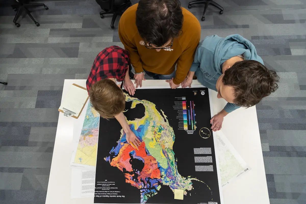 Southern Utah University students looking at a map in a lab studying geology for the Geosciences Bachelors degree.