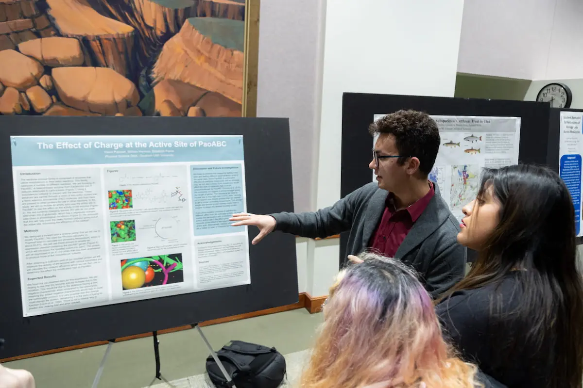 Southern Utah University students with professor examining a display of geospatial science for the Geospatial Science Bachelors degree.