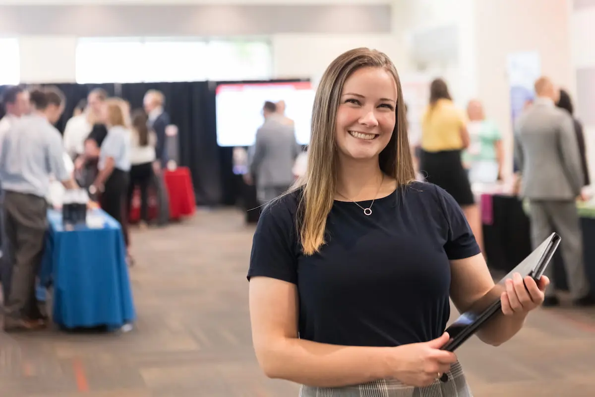 Southern Utah University Management, Hotel, Resort, and Hospitality Management student in event room.