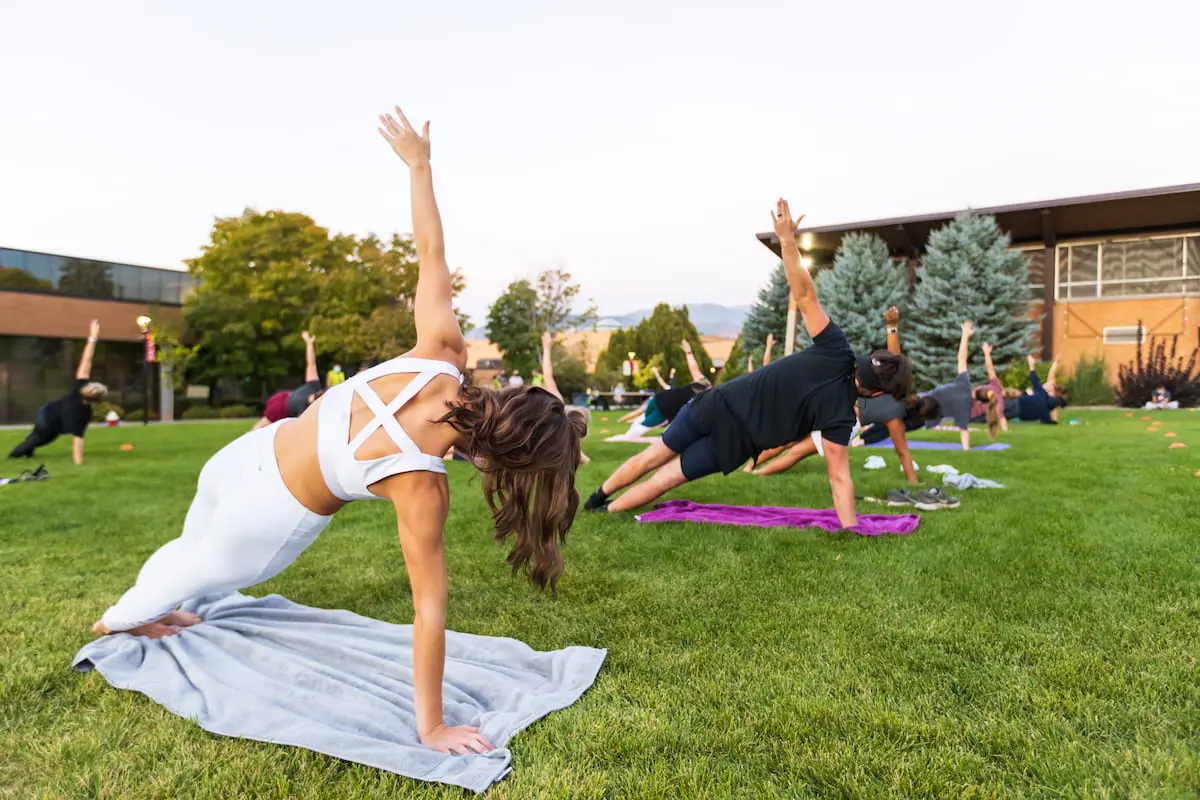 Southern Utah University students doing yoga on campus lawn for Integrative Health Sciences Bachelor Degree Program.