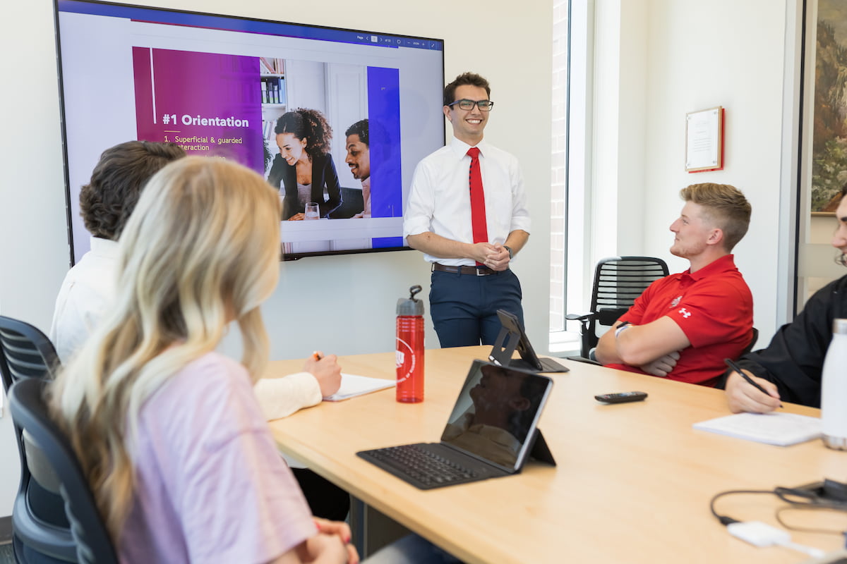 Southern Utah University Marketing Bachelor Degree student giving a power point presentation to a group of people.