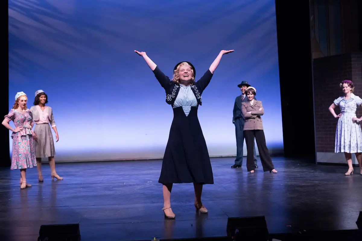 Musical Theatre student performing a musical surrounded by other students at Southern Utah University on their way to earning a bachelor degree.