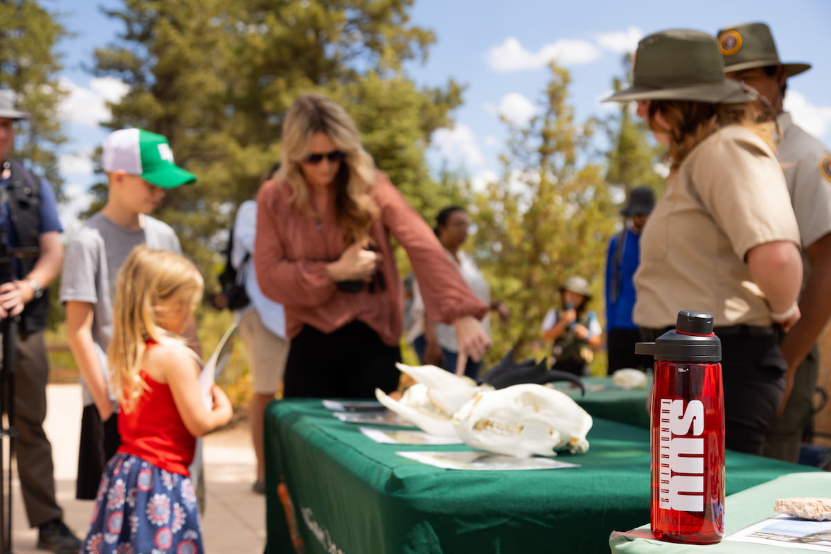 Southern Utah University students talking with the public outdoors for the Bachelors degree.