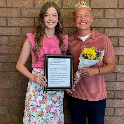 Cami Carlson with a student being awarded for academic achievement