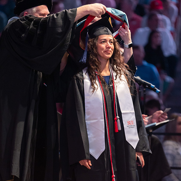 Masters graduate receiving hooding