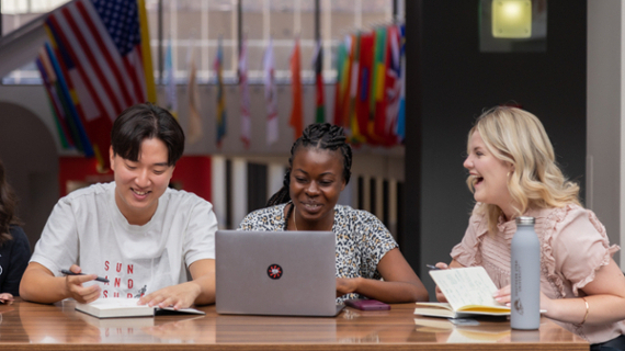 University students studying together and laughing.