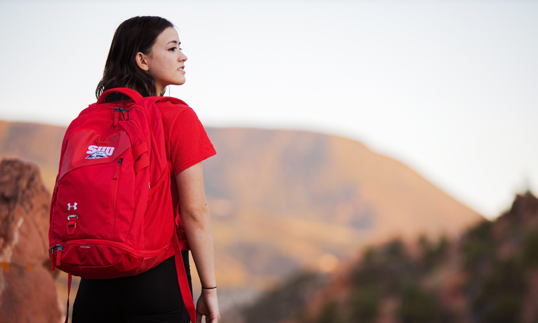 A student with mountains in the distance.