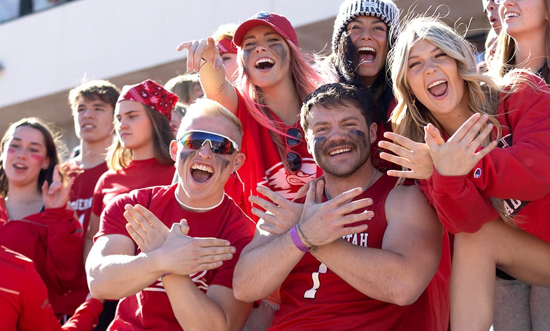 SUU students at an SUU football game, posing