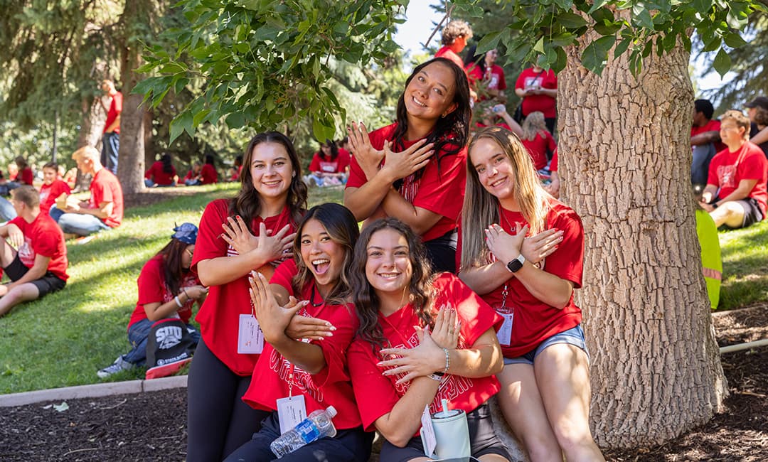 SUU students wearing red shirts and posing on the upper quad