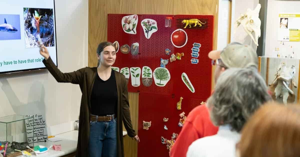 A woman giving a tour of the Frehner museum