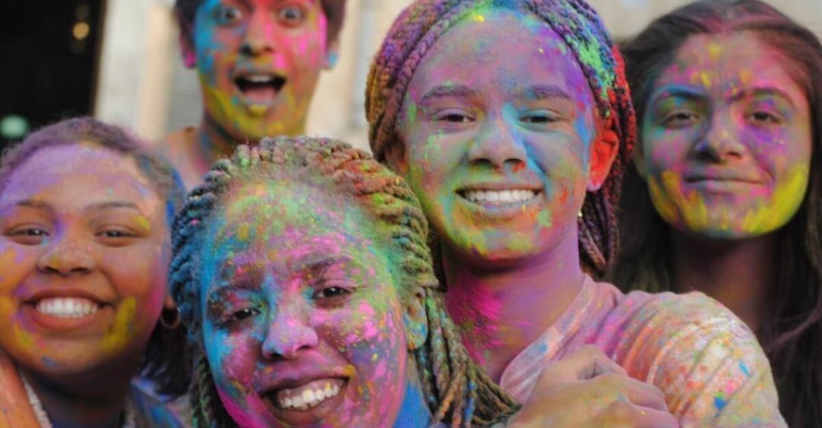 Students covered in colorful chalk