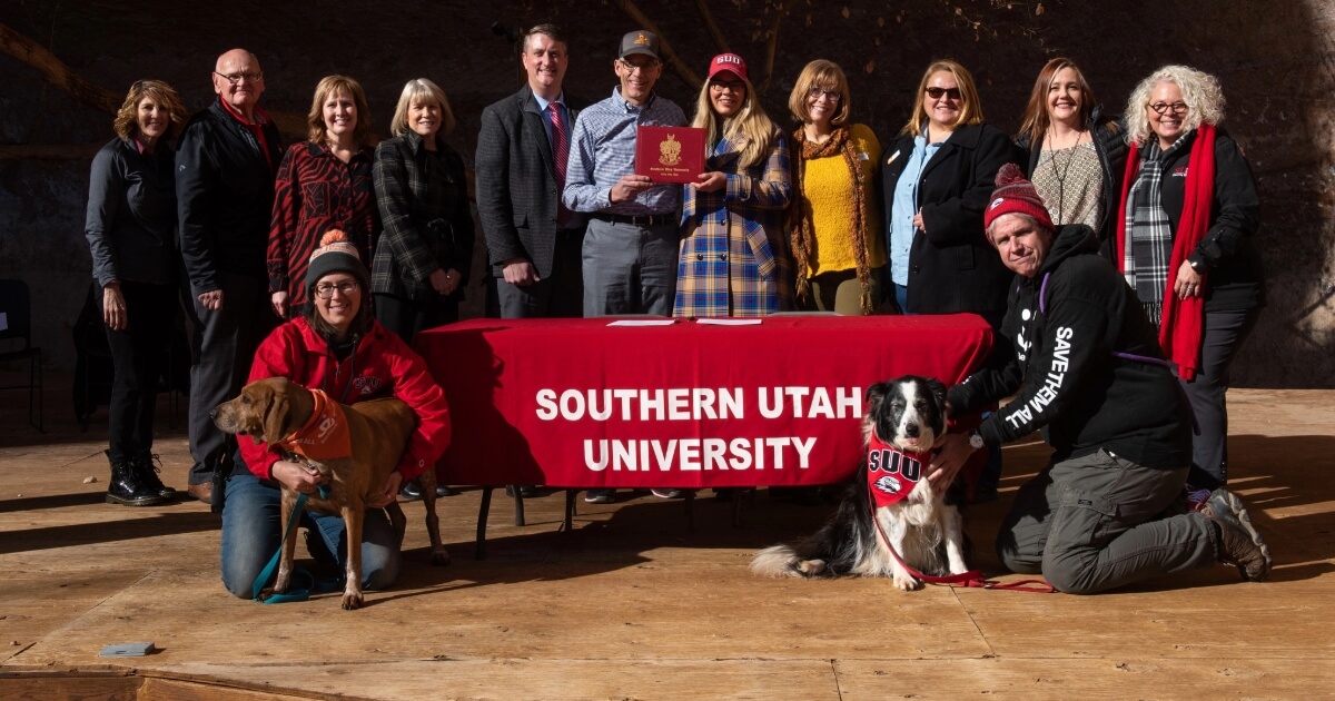 Best Friends organization posing with dogs and award