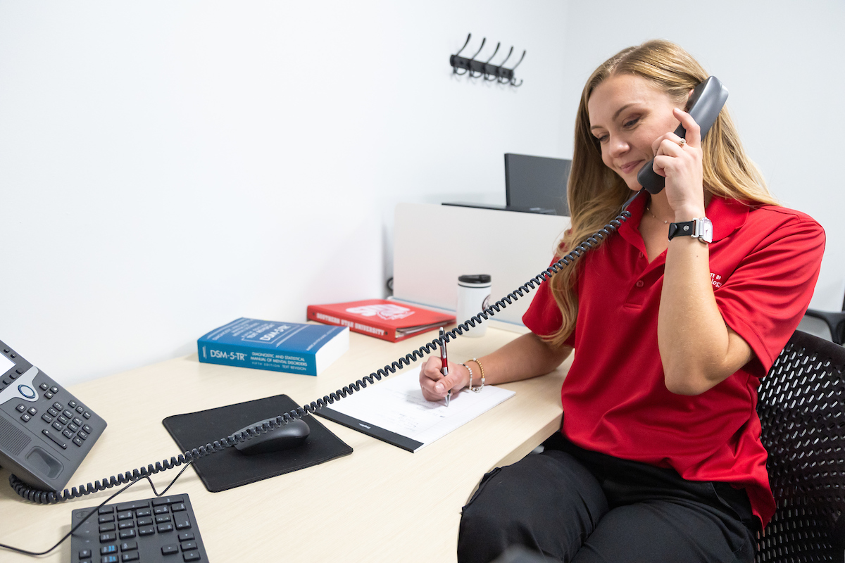 Women talking on phone call with student