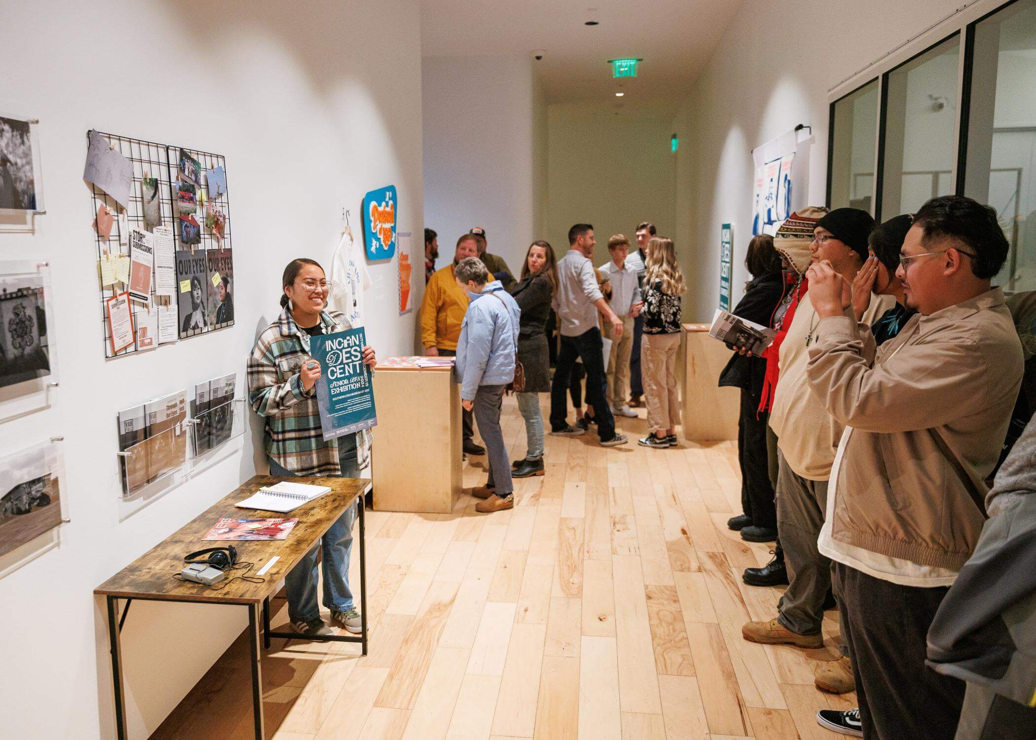 Jade Warren, Graphic Designer posing with her exhibition