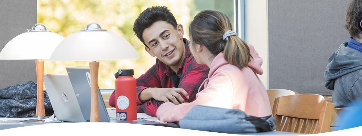 Two students talking in the SUU Library